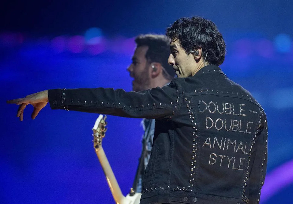Joe Jonas of the Jonas Brothers wears a beaded jacket with an homage to In-N-Out Burger double-double animal style as he performs Friday at Golden 1 Center.