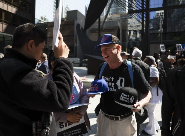 A vendor advertises his "Don't Annoy Illinois" hats for sale after an interfaith LIVE FREE Illinois rally in Daley Plaza on Sept. 8, 2025. (Eileen T. Meslar/Chicago Tribune)