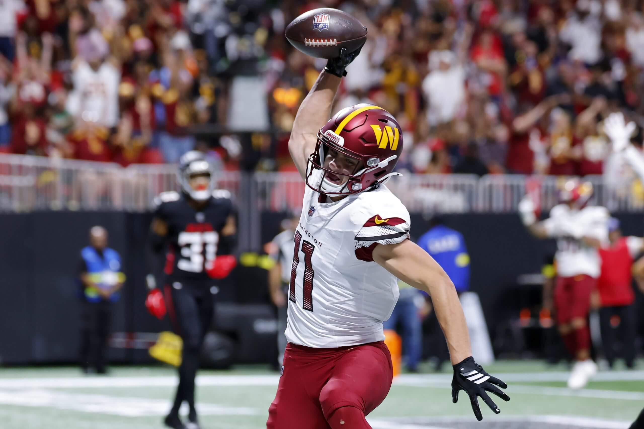 Luke McCaffrey spikes a football after scoring a touchdown against the Atlanta Falcons. 