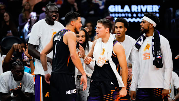 Phoenix Suns guard Devin Booker (1) and the Suns bench react to a three point shot by Booker in the second half Phoenix Suns guard Devin Booker (1) and the Suns bench react to a three point shot by Booker in the second half