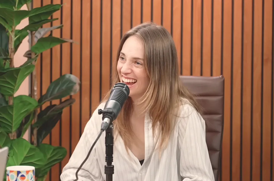 Maya laughing on a podcast