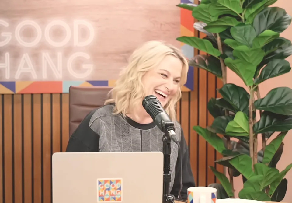 Amy laughing on a podcast set