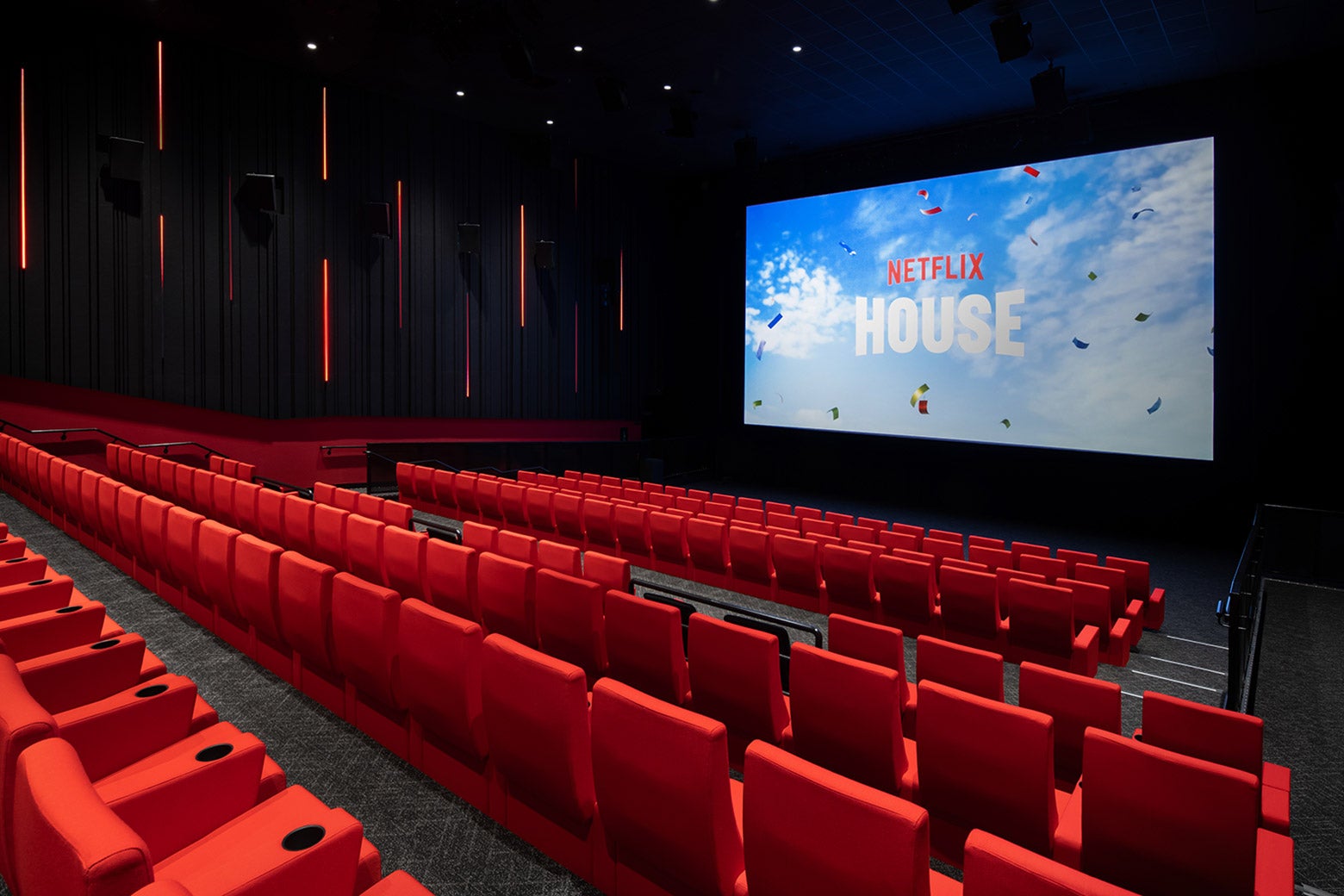 Tudum Theater, a movie theater with red seats and a screen with the words "Netflix House."