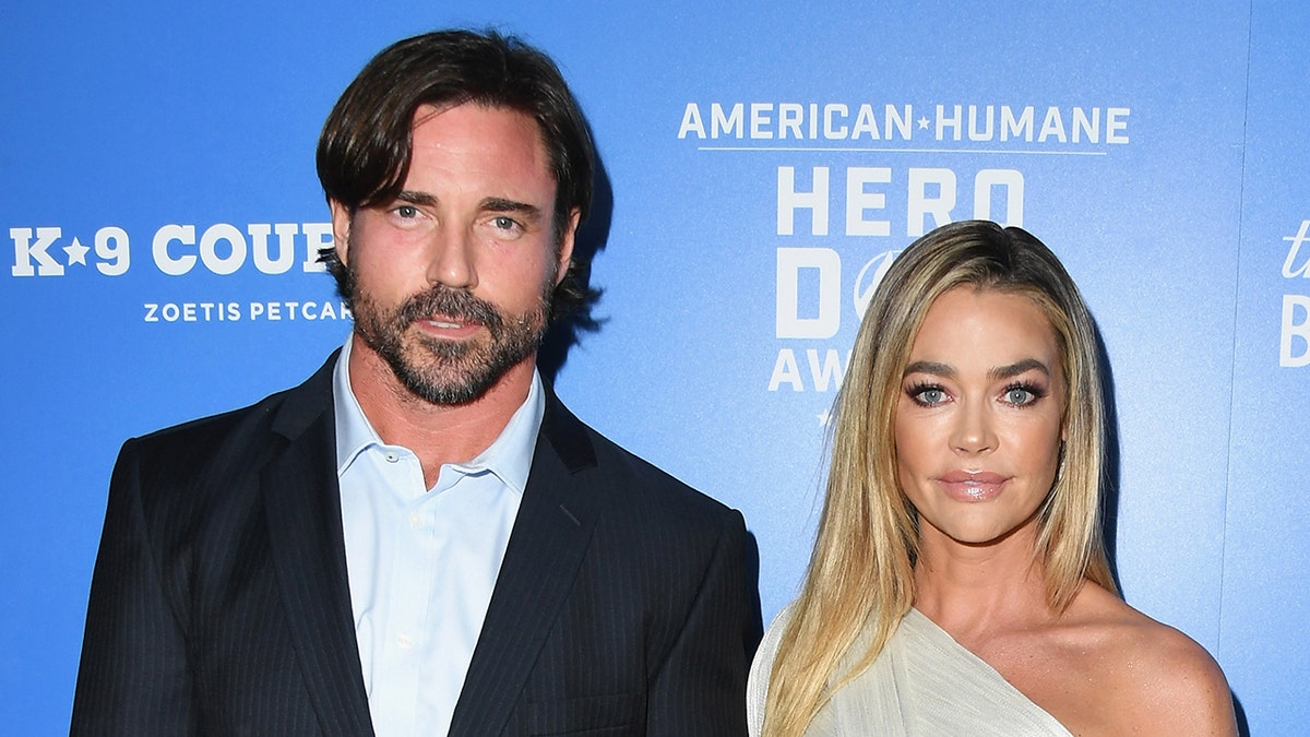Denise Richards and Aaron Phypers on a red carpet.