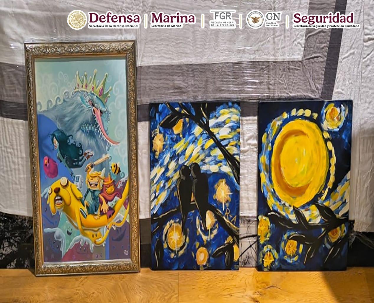 Three paintings lined up against a wall.