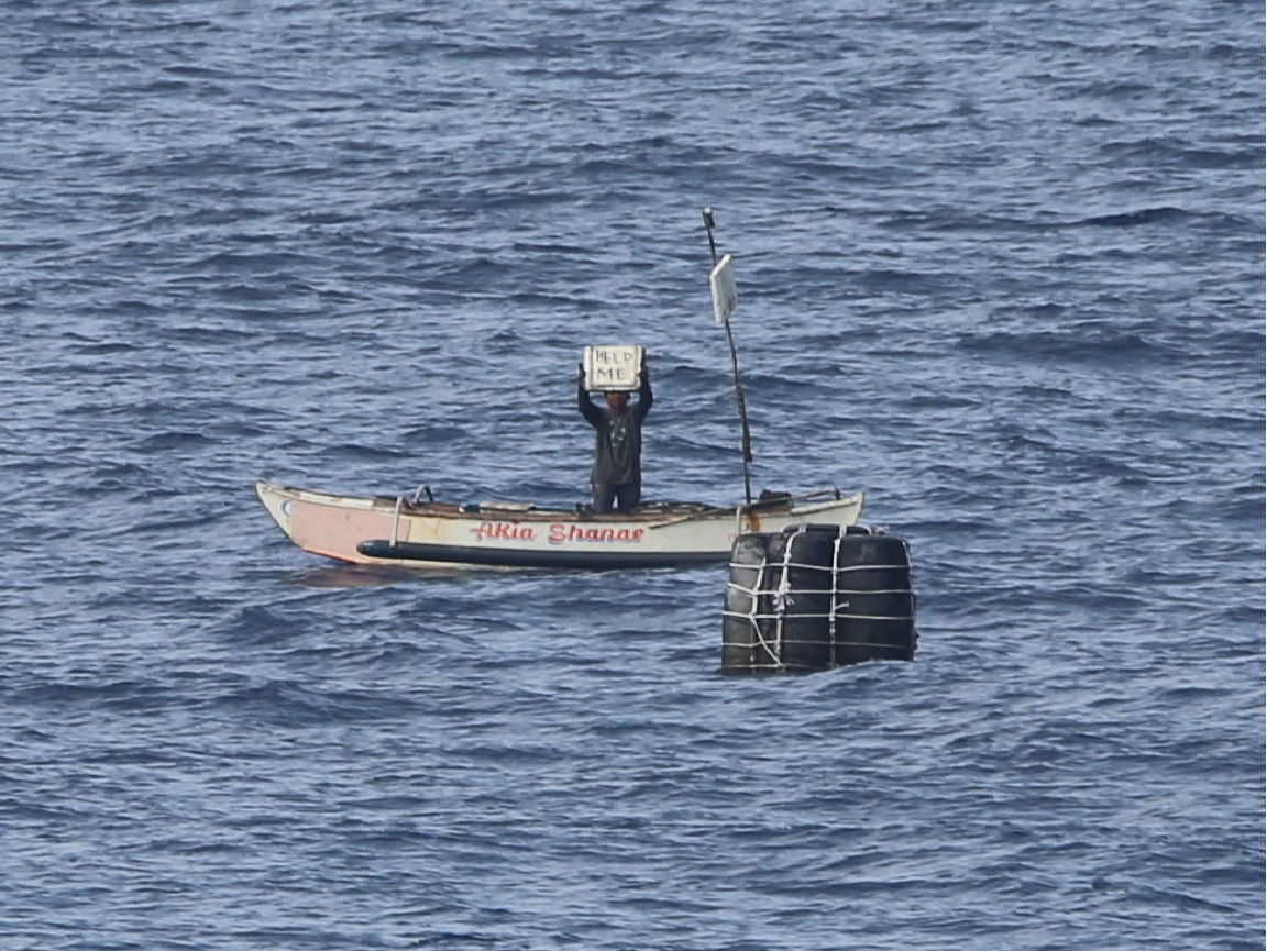A Philippine fisherman is seen seeking assistance from a Chinese People's Liberation Army Navy  warship at sea. Photo: Source 