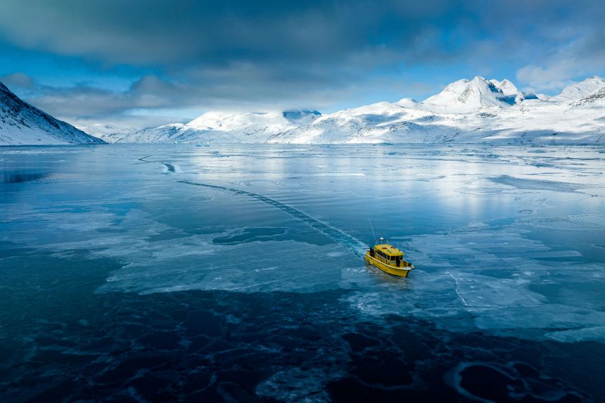 A boat travels though a frozen sea inlet outside in Nuuk, Greenland, March 6.