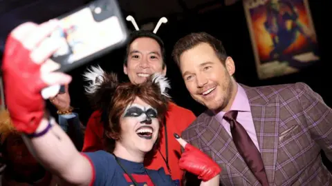 Getty Images Guardians of the Galaxy fans dressed in costumes of characters from the film with Chris Pratt at the premiere of the third film - they are taking a selfie