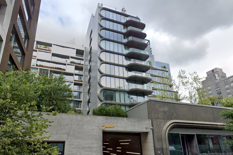 Modern mixed-use building with balconies and greenery