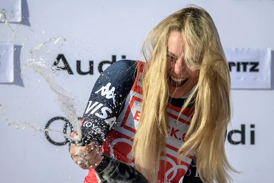 First-placed US Lindsey Vonn celebrates on the podium with sparkling wine after competing in the women's downhill race during the FIS Alpine Ski World Cup 2025-2026, in St Moritz, south-eastern Switzerland on December 12, 2025. (Photo by Fabrice COFFRINI / AFP via Getty Images)