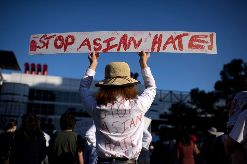 Sally Sha holds up a sign during a Stop Asian Hate rally at Discovery Green in downtown Houston, Texas, on March 20, 2021.