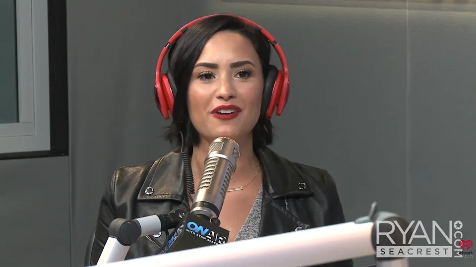 Demi speaking in a radio studio