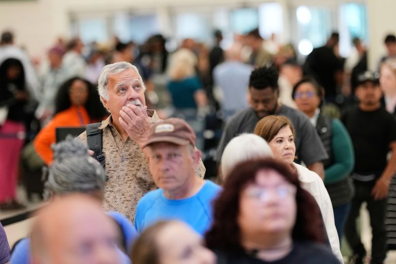 Passengers wait in a security checkpoint line at George Bush Intercontinental Airport, Wednesday in Houston.