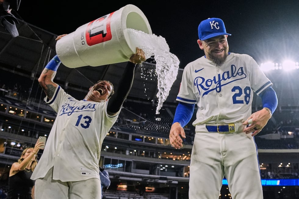 Kansas City Royals' Salvador Perez (13) douses Kyle Isbel (28) after their baseball game...