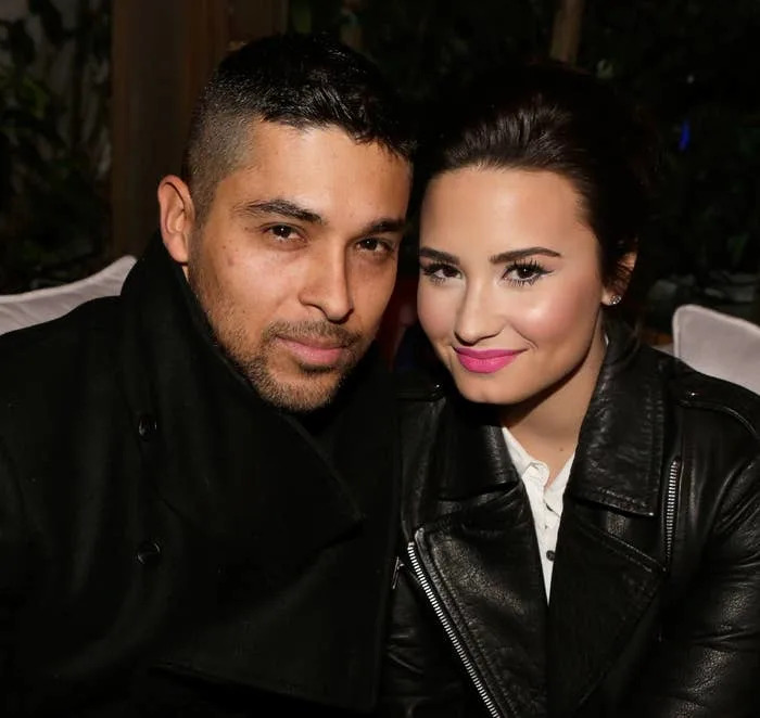 Wilmer and Demi sitting closely together, both smiling
