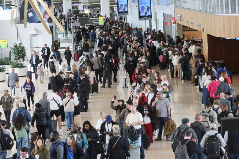 People wait in long security lines at LaGuardia Airport on Wednesday in the Queens borough of New York City.
