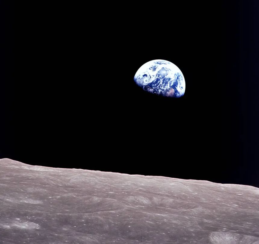 Taken by Bill Anders aboard Apollo 8, this iconic picture shows Earth peeking out from beyond the lunar surface as the first crewed spacecraft circumnavigates the moon.<br />Image Credit: NASA