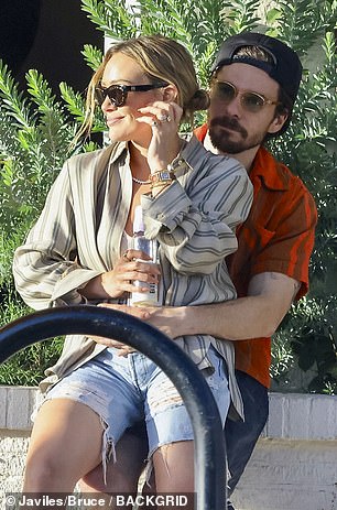 He wrapped both arms around her waist