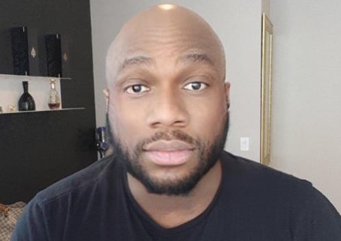 A bearded man in a black t-shirt