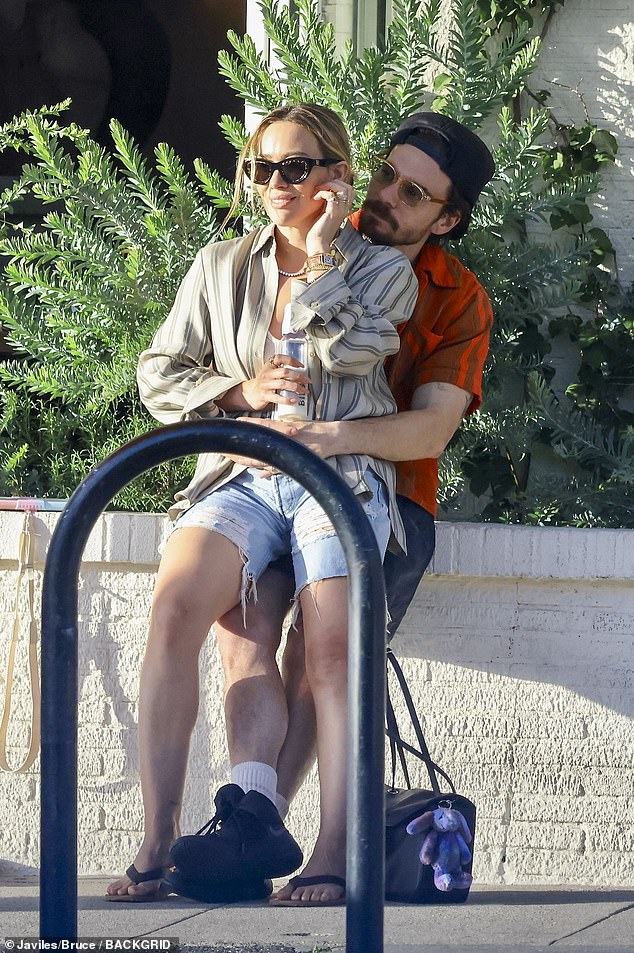 Hilary Duff sits on her husband Matthew Koma’s lap before lunch in Studio City