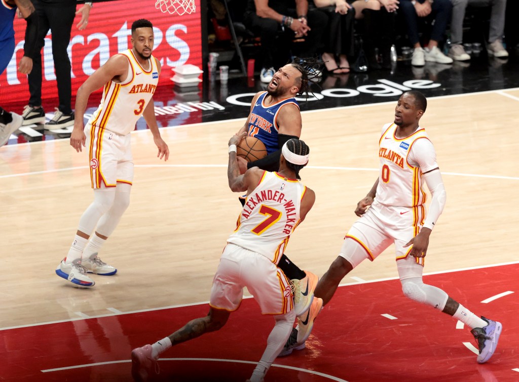 Jalen Brunson (11) goes up for a shot as Atlanta Hawks guard Nickeil Alexander-Walker (7) fouls during the fourth quarter. 
