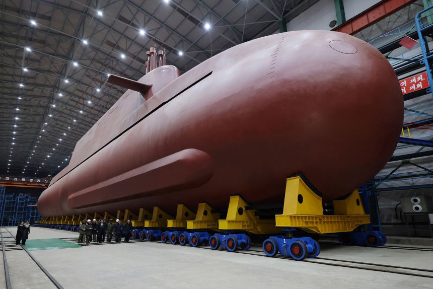 North Korean leader Kim Jong Un visits the construction site of what North Korea says is an 8,700-ton nuclear-powered submarine on December 25, 2025.