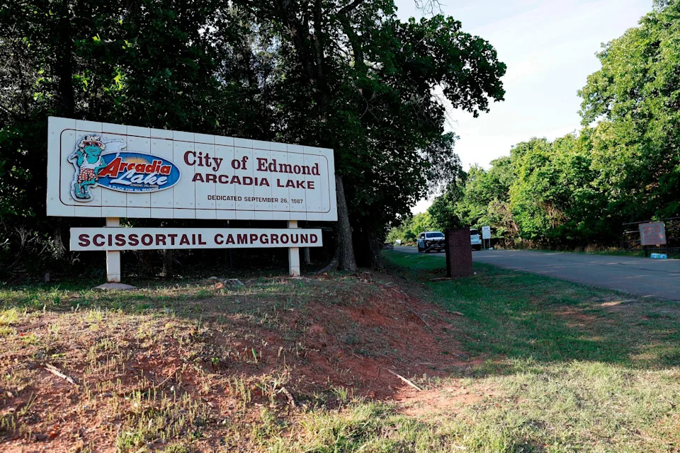 Alonzo Adams/AP - PHOTO: Police block the entrance to Scissortail Campground at Arcadia Lake, May 4, 2026, in Edmond, Okla., after a mass shooting on Sunday evening.