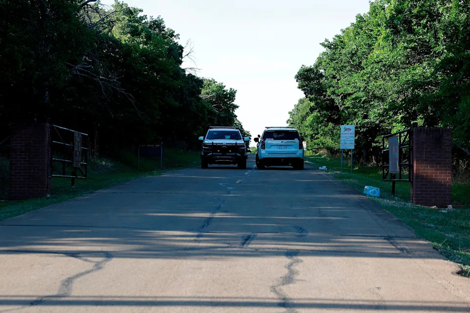 Alonzo Adams/AP - PHOTO: Police block the entrance to Scissortail Campground at Arcadia Lake, May 4, 2026, in Edmond, Okla., after a mass shooting Sunday evening.