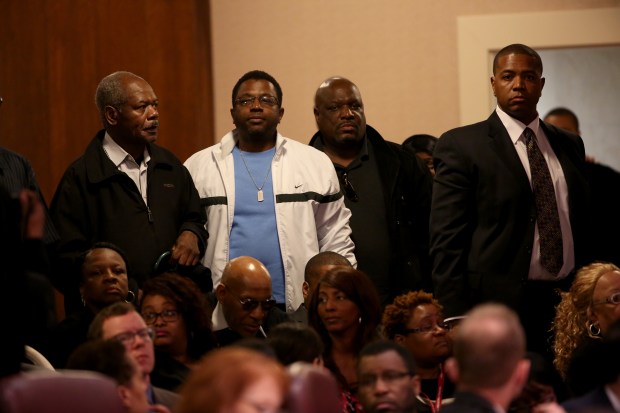 Victims of former Chicago police Cmdr. Jon Burge stand to be honored by the Chicago City Council on May 6, 2015. (Nancy Stone/Chicago Tribune)