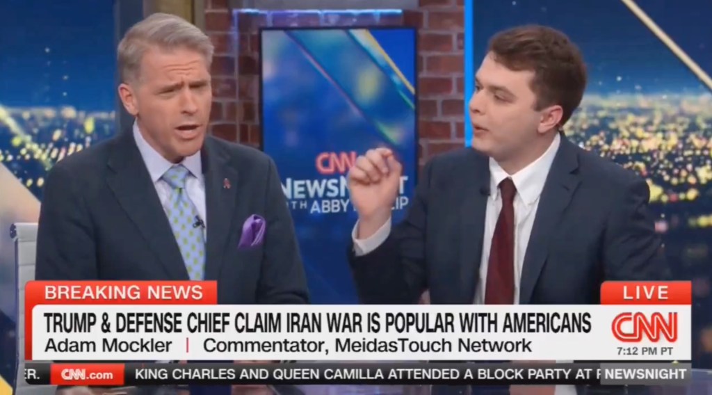 Two men in suits, Scott Jennings and Adam Mockler, debate on CNN's NewsNight, with a headline "TRUMP & DEFENSE CHIEF CLAIM IRAN WAR IS POPULAR WITH AMERICANS."