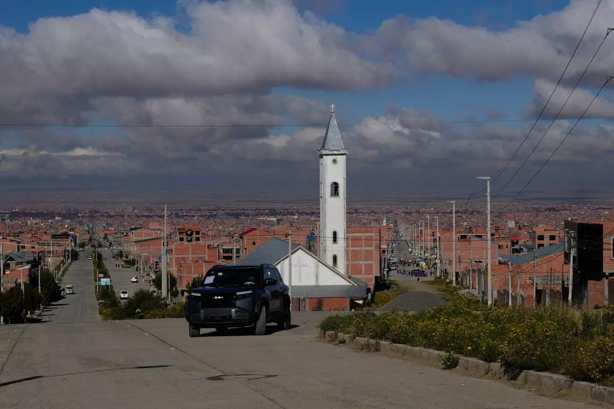 Simón Huanca drives his electric vehicle through the streets of El Alto, Bolivia, Friday, April 24, 2026. (AP Photo/Juan Karita)
