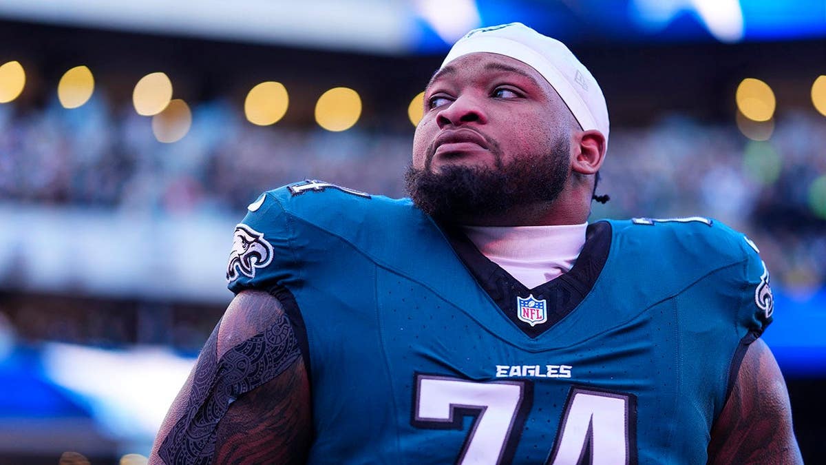 Fred Johnson of the Philadelphia Eagles standing on the sideline during the national anthem