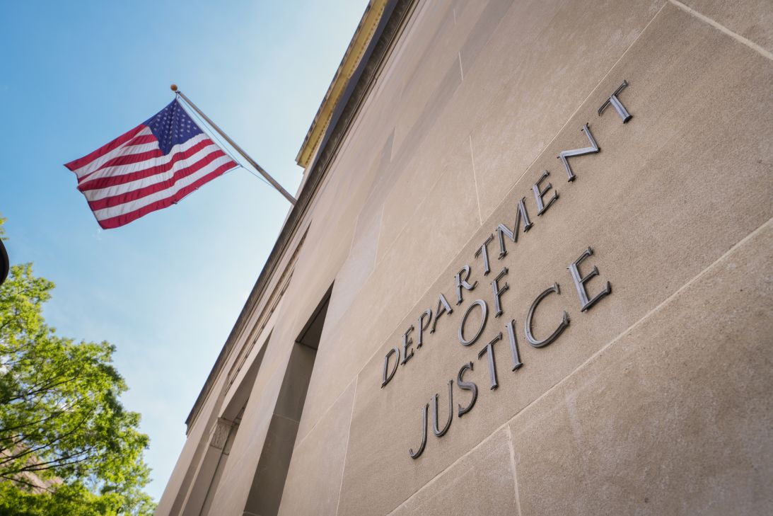 A sign marks the location of the US Department of Justice (DOJ) headquarters building on April 30, 2025, in Washington, DC.