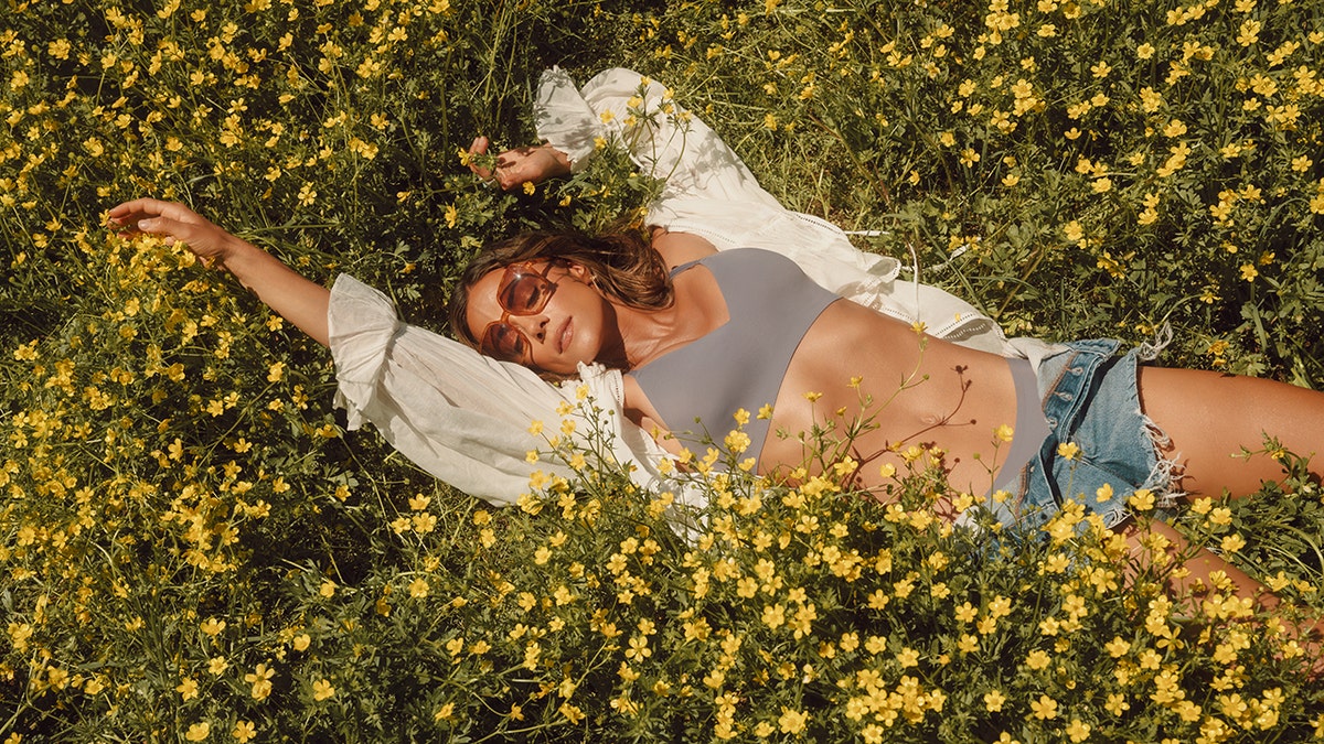 Jana Kramer in a field of flowers for a promotional shoot for her campaign with EBY.